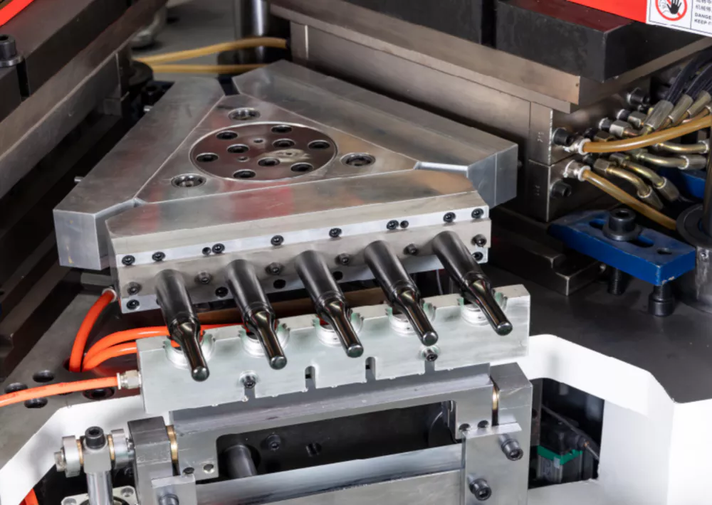 IBM injection blow molding machine shown alongside ISBM stretch rod technology for comparison