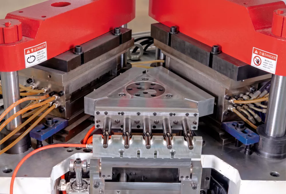 IBM injection blow molding machine showing rotary station design for high-speed bottle production